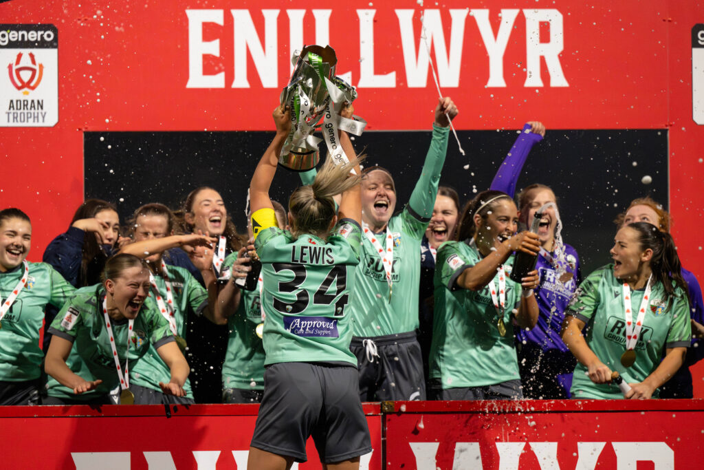 The New Saints celebrate with champagne as they lift the Genero Adran Trophy